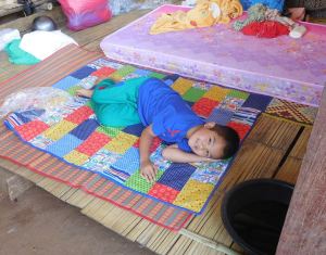 boy at Huayjakan and quilt